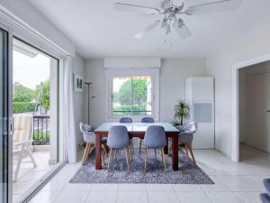 a dining room with a table and chairs at Appartement moderne près de la plage avec balcon et Wi-Fi à Hendaye - FR-1-2-394 in Hendaye +8 photos