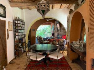 a dining room with a table and chairs at RIAD CHANT D'ETOILES tadighoust in El Hara