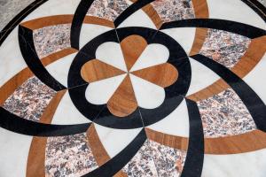 a close up of a mandala painting on a tile floor at OZO Hotels Cordial Amsterdam in Amsterdam