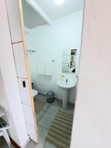 a bathroom with a toilet and a sink at Cape Cozy Cottages in Cape Town