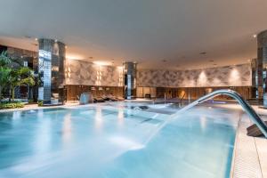 - une piscine dans le hall de l'hôtel avec une grande piscine dans l'établissement Grand Hyatt Barcelona, à Barcelone