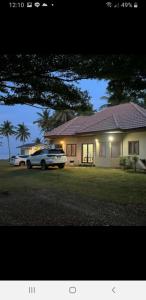 a car parked in front of a house at Baan Be Beach in Lang Suan