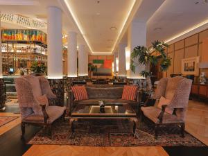 a lobby with chairs and a couch and a bar at BLESS Hotel Madrid - The Leading Hotels of the World in Madrid