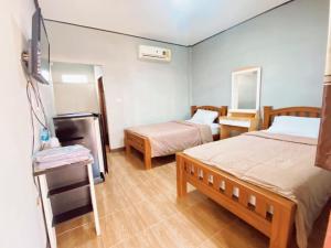Postel nebo postele na pokoji v ubytování โรงแรม MT homestay