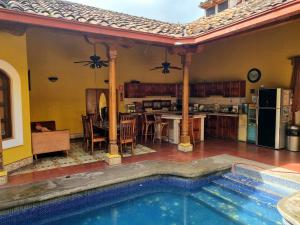 a house with a swimming pool next to a kitchen at Casa del Agua in Granada