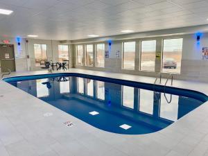 a large swimming pool in a large building at Days Inn and Suites by Wyndham Hammond, IN in Hammond