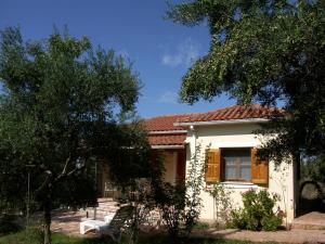 a small white house with a red roof at IONIANEON APARTMENTS in Áyios Ilías