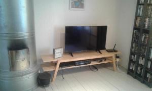 a television sitting on a wooden table in a room at Holiday House in Lapland, Överkalix in Överkalix