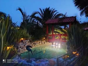 a swimming pool in a resort at night at Hotel Palmas Teotihuacán in San Juan Teotihuacán
