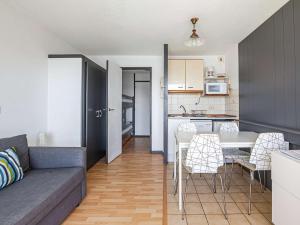 a living room and kitchen with a couch and a table at Studio Hendaye, 1 pièce, 4 personnes - FR-1-2-284 in Hendaye