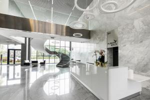 a lobby with a staircase in a building at Wola Lush Apartment in Warsaw