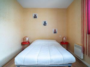 アンダイエにあるAppartement Hendaye, 2 pièces, 5 personnes - FR-1-2-299のベッドルーム1室(ベッド1台、赤い椅子2脚付)