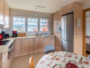 a kitchen with a table and a stainless steel refrigerator at Appartement Hendaye, 2 pièces, 4 personnes - FR-1-2-302 in Hendaye