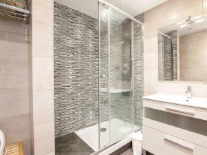 a bathroom with a glass shower and a sink at Appartement rénové avec piscine et accès plage à Hendaye - FR-1-2-335 in Hendaye