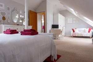a white bedroom with red towels on a bed at Number Two in Southampton