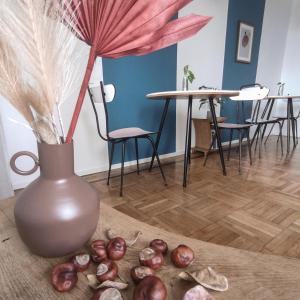 a vase with a pink flower and some onions on the floor at Casa Tulù B&B in Bologna