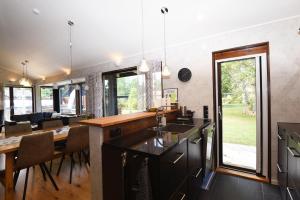 a kitchen and dining room with a table and chairs at Nice holiday home with outdoor pool in Lottorp, Oland in Löttorp