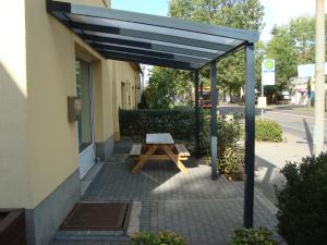 a picnic table under awning outside of a building at Trothaer Eck in Kröllwitz