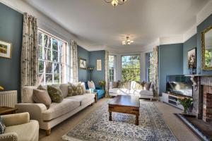 a living room with a couch and a tv at Harkstead Hall By Group Retreats in Ipswich