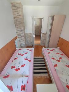 two beds in a room with a hallway at M&R apartmani Rovinj in Rovinj