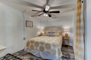 a bedroom with a bed and a ceiling fan at 5 bed 4 bath pool table fire pit walk to beach in Daytona Beach