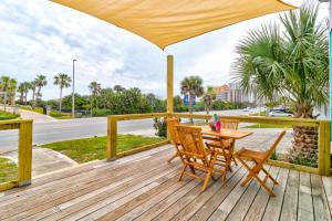 a wooden deck with a table and chairs on it at 5 bed 4 bath pool table fire pit walk to beach in Daytona Beach