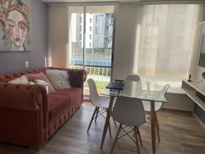 a living room with a couch and a table at Apartahotel in Ibagué