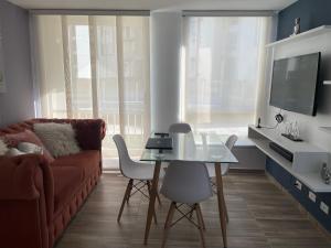 Apartahotel في إباغويه: غرفة معيشة مع أريكة وطاولة