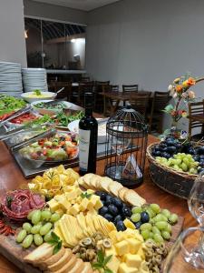 a table with a bunch of different types of food at Hotel Villa das Termas in Marcelino Ramos