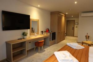 a hotel room with a television on the wall at The Teifi Waterside Hotel in Cardigan