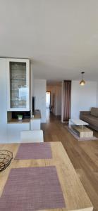 a living room with a couch and a table at Luxury panorama apartament,Coresi in Braşov