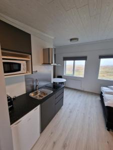 a kitchen with a sink and a counter top at Aurora Cabins in Höfn