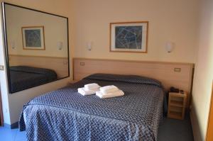 Postel nebo postele na pokoji v ubytování Hotel Nizza
