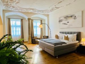 a bedroom with a bed and a living room at Stadthotel Styria in Steyr