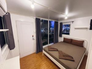 a small bedroom with a bed and a window at 3199 Cafe' Latya 