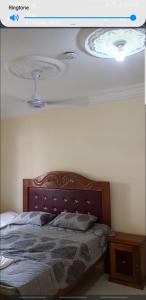 a picture of a bedroom with a bed with a ceiling at The bb's in Brusubi