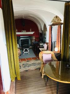 a living room with a table and a fireplace at Casa Bibiana in Posadilla