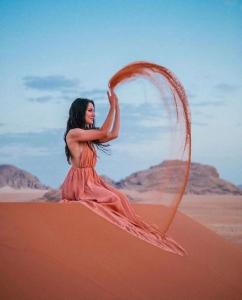 a woman in a dress in the desert at Desert Moon Camp in Wadi Rum