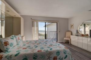 a bedroom with a bed and a view of the ocean at Blue Skies Oceanfront 2 bedroom townhouse in Ponce Inlet