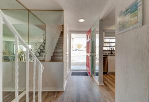 a hallway of a home with a staircase and a house at Dolphin Watcher 2 Bed Townhouse in Ponce Inlet