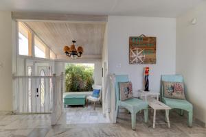a living room with two chairs and a table at Beachfront 4 Bedroom 4 Bath with Huge Deck Wifi in Daytona Beach