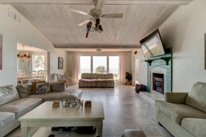 a living room with a ceiling fan and a fireplace at Beachfront 4 Bedroom 4 Bath with Huge Deck Wifi in Daytona Beach