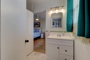 a bathroom with a sink and a mirror and a bed at Beachfront 4 Bedroom 4 Bath with Huge Deck Wifi in Daytona Beach +49 photos