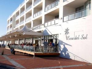 a group of people standing outside of a building at Beachfront Gem / Free Parking / A/C in Cape Town