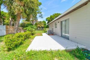 a walkway leading to the side of a house at Coquina Cabana with fenced yard and adorable decor in South Daytona