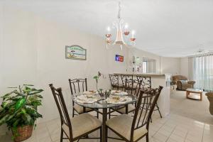 a dining room and kitchen with a table and chairs at Cozy Ocean Condo with Pool Small Dog Friendly in Ormond Beach