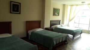 Postel nebo postele na pokoji v ubytování El Cardenal Hotel