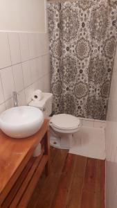 a bathroom with a toilet and a sink and a shower at The Lighthouse at Casa Max in Bocas del Toro