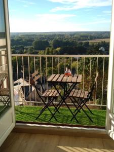 a table and chairs on a balcony with a view at LA SALAMANDRE in Blois