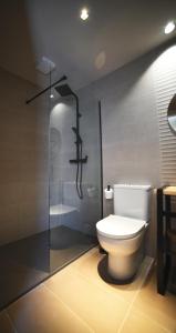 a bathroom with a toilet and a shower at IMI Hotel & Spa in Ourense